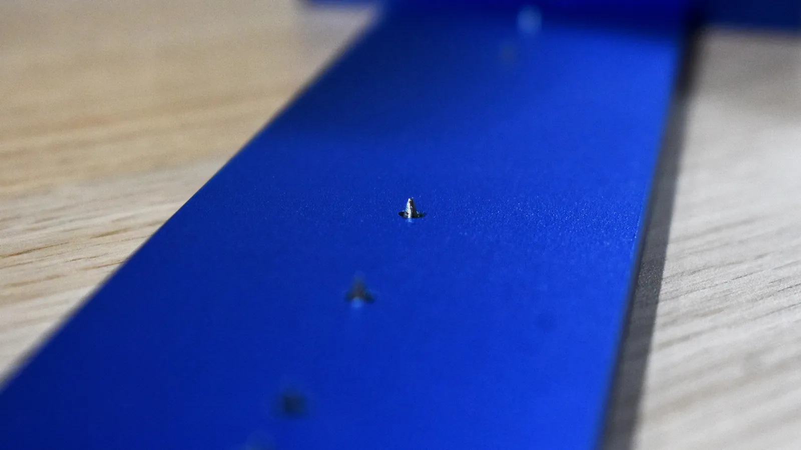 Macro of the marking pins on the D32 blue aluminum body