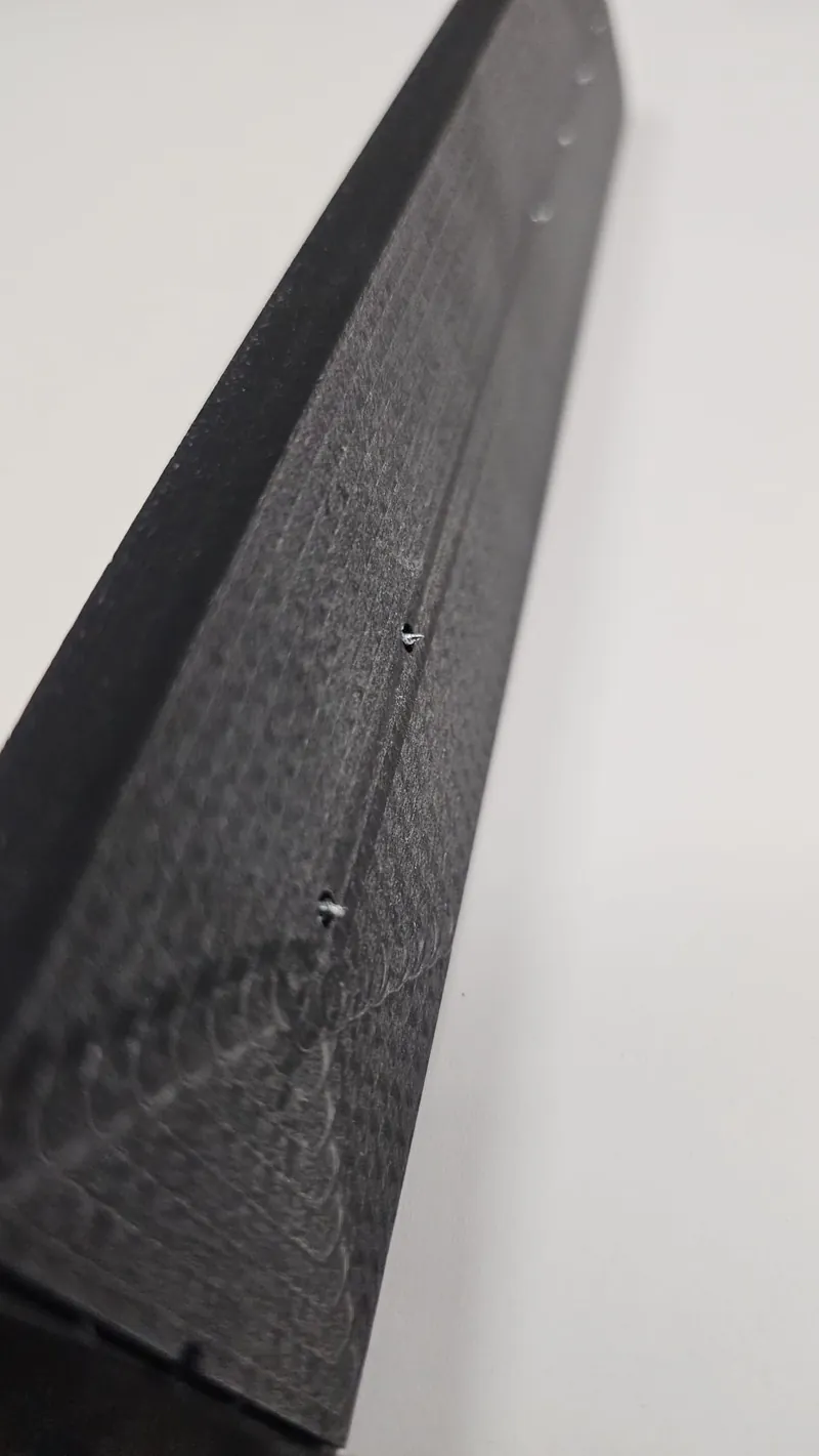 Close-up of the CNC-machined prototype showing the marking pins